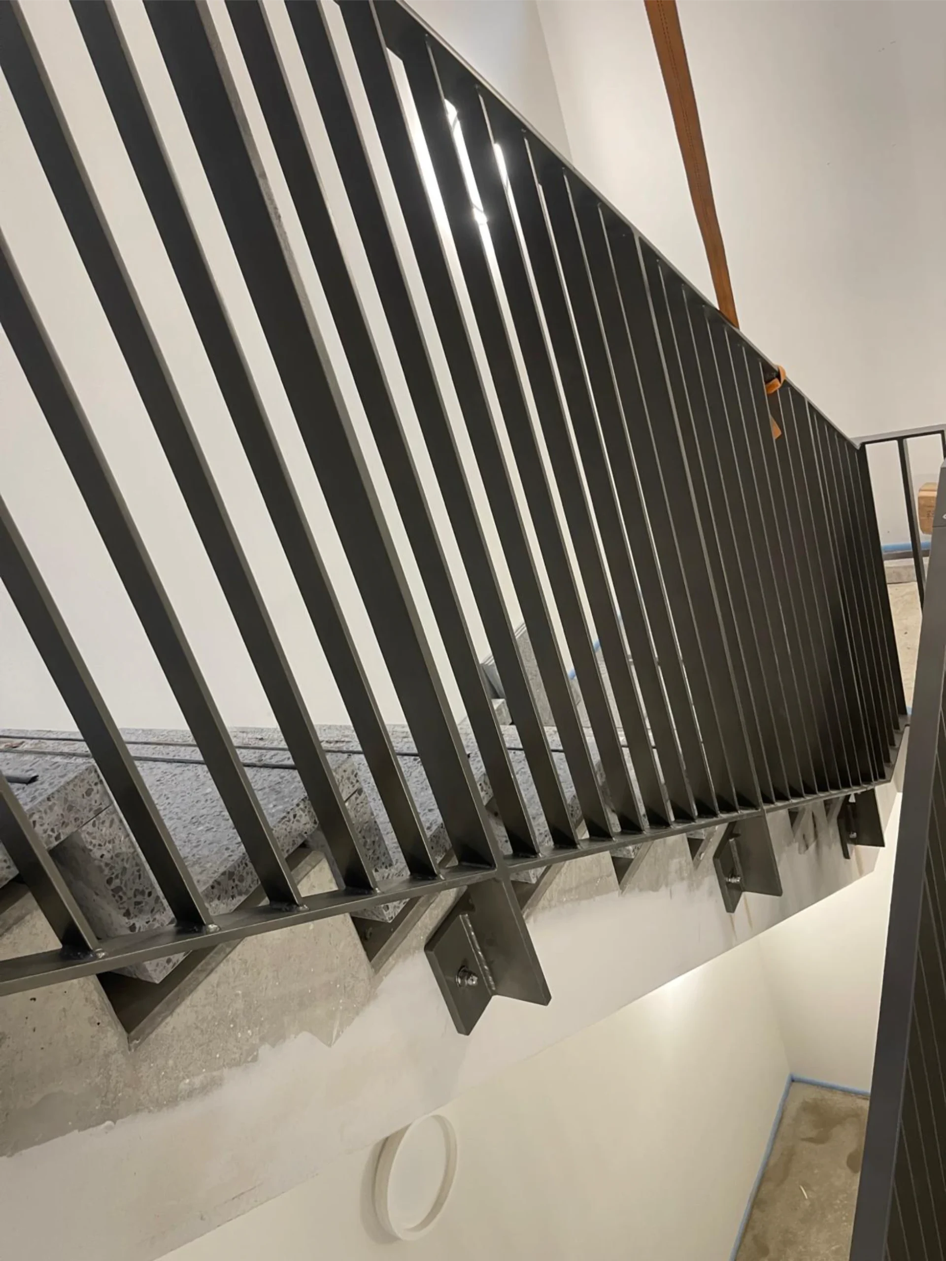 Detailansicht eines modernen Treppengeländers aus Metall. Präzise Stahlkonstruktionen für sichere und stilvolle Innenräume.